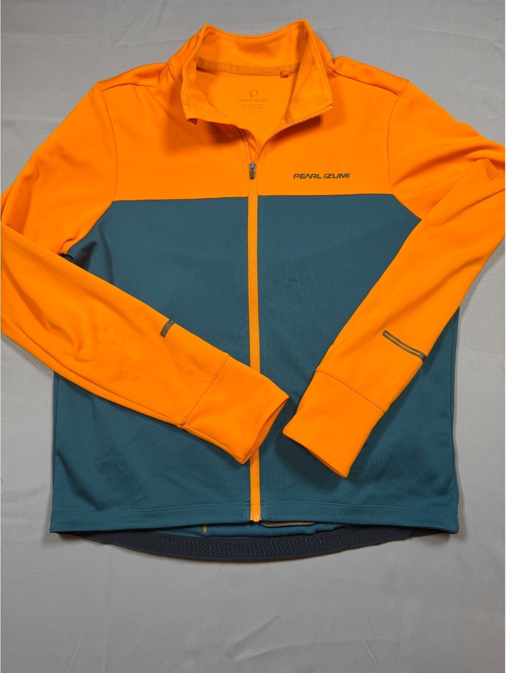 Pearl Izumi orange and teal cycling jacket